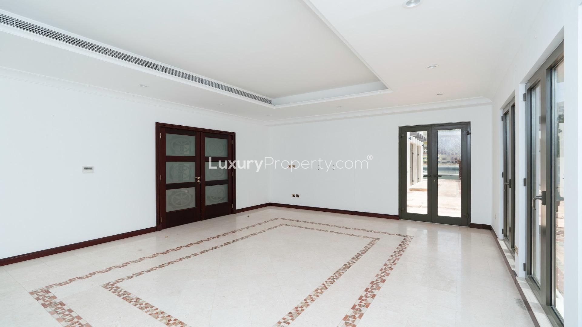 Palm Jumeirah villa with private beach and marina view in Garden Homes community
