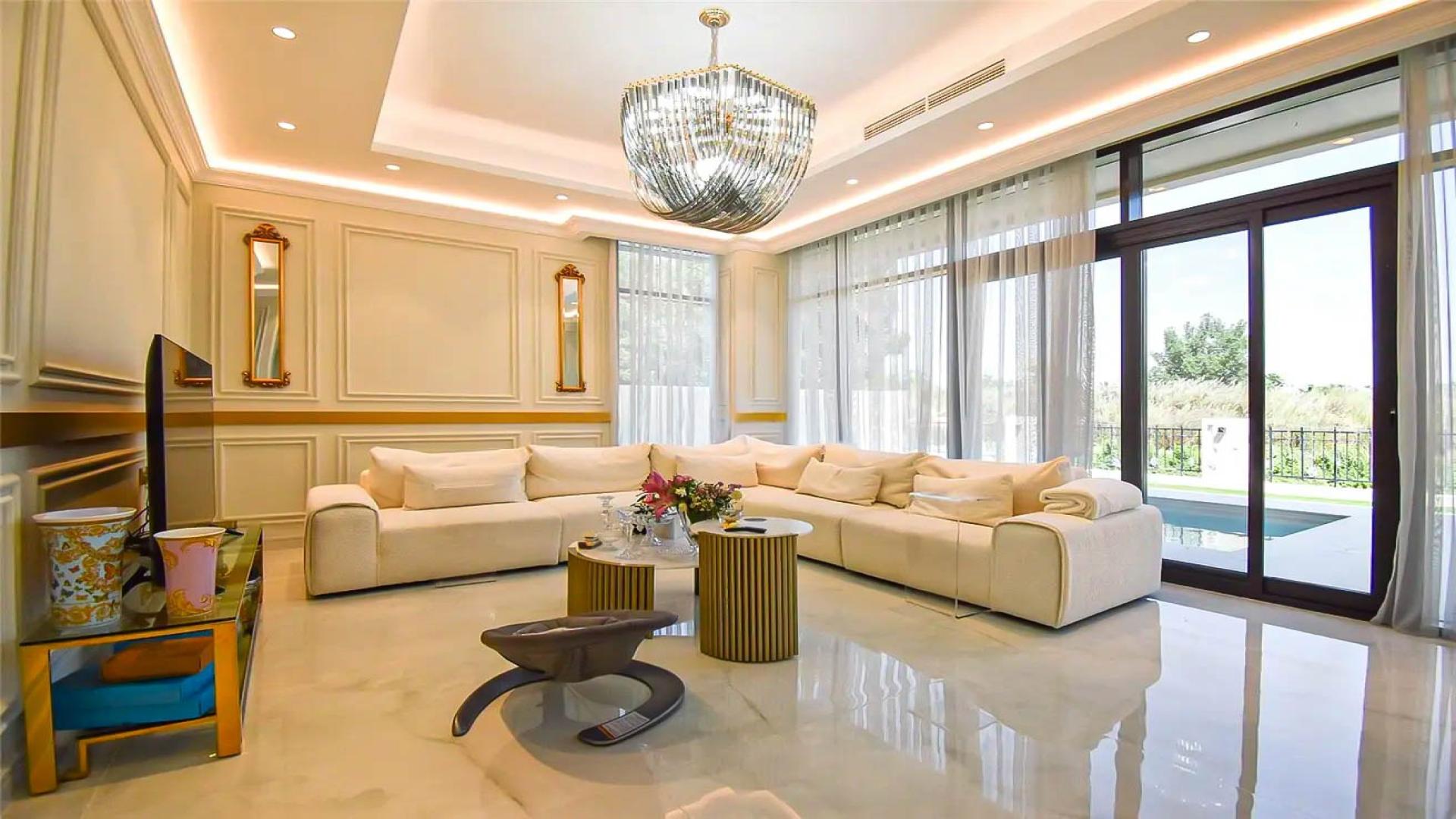 "Modern 4-bedroom villa with pool, park and lake view in Damac Hills, Longview community.",Luxurious living room in upgraded Damac Hills villa with park and lake view