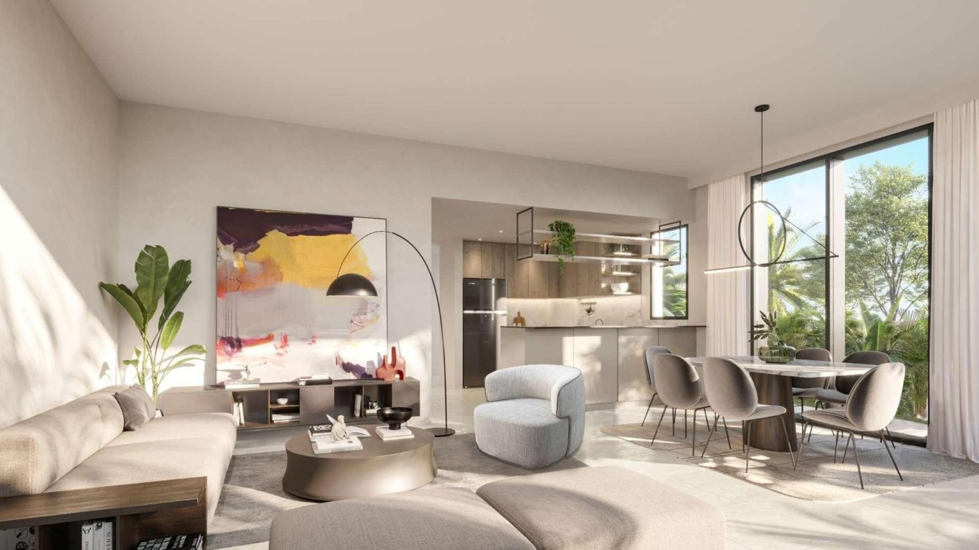 Modern twin villa in Aura Phase 2, Tilal Al Ghaf, with lush landscaping and parking