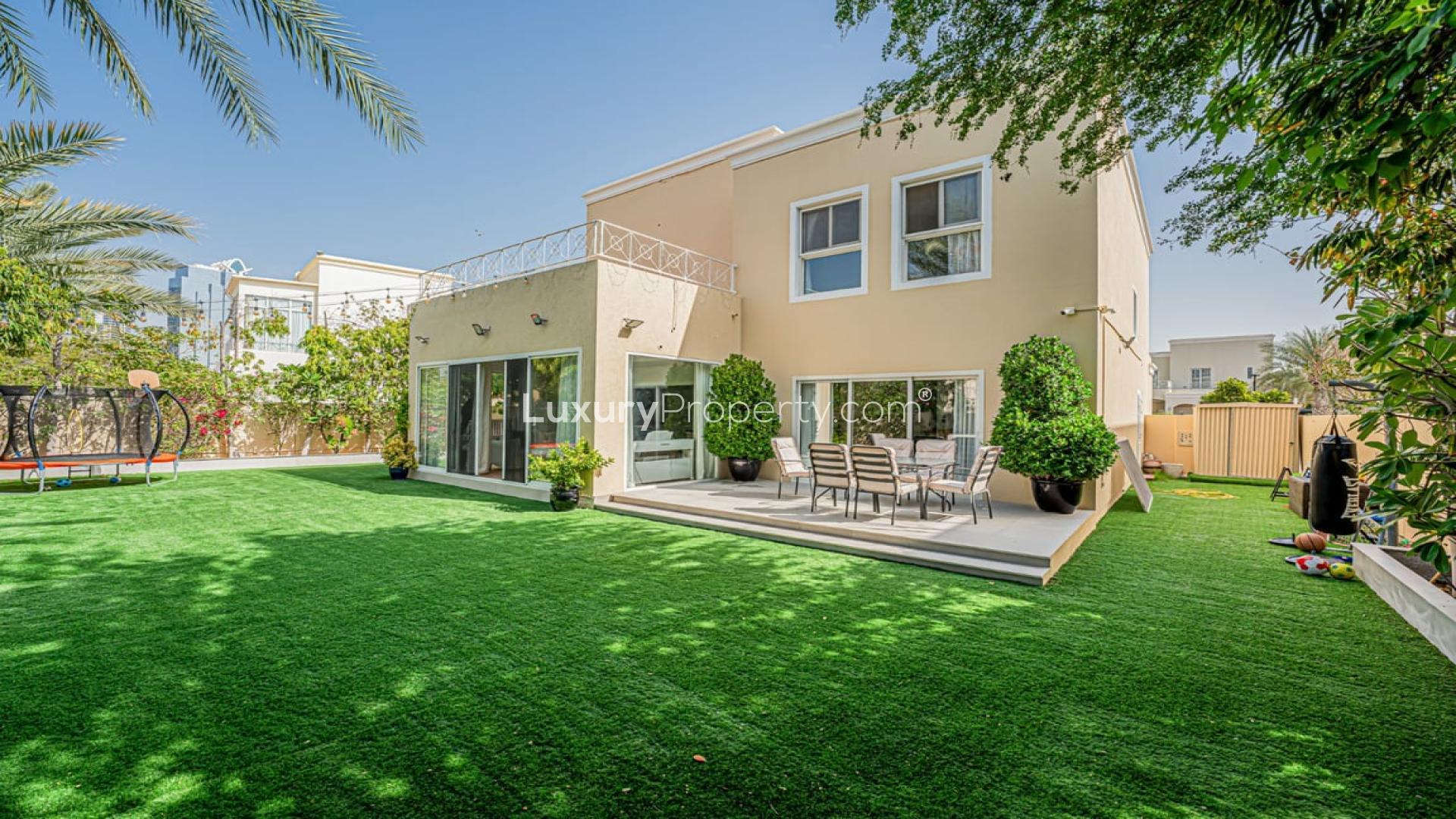 Fully extended villa with spacious backyard in Meadows 1, featuring lush landscaping and patio