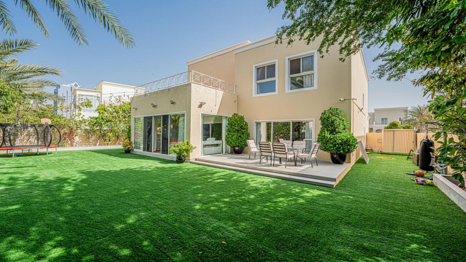 Fully extended villa with spacious backyard in Meadows 1, featuring lush landscaping and patio