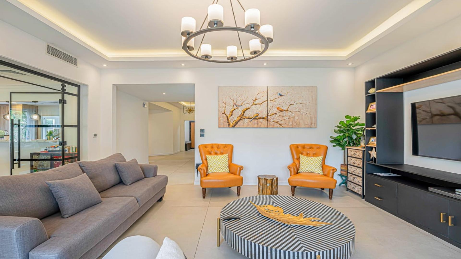 Luxury living room in Dubai Marina villa with modern decor and garden view