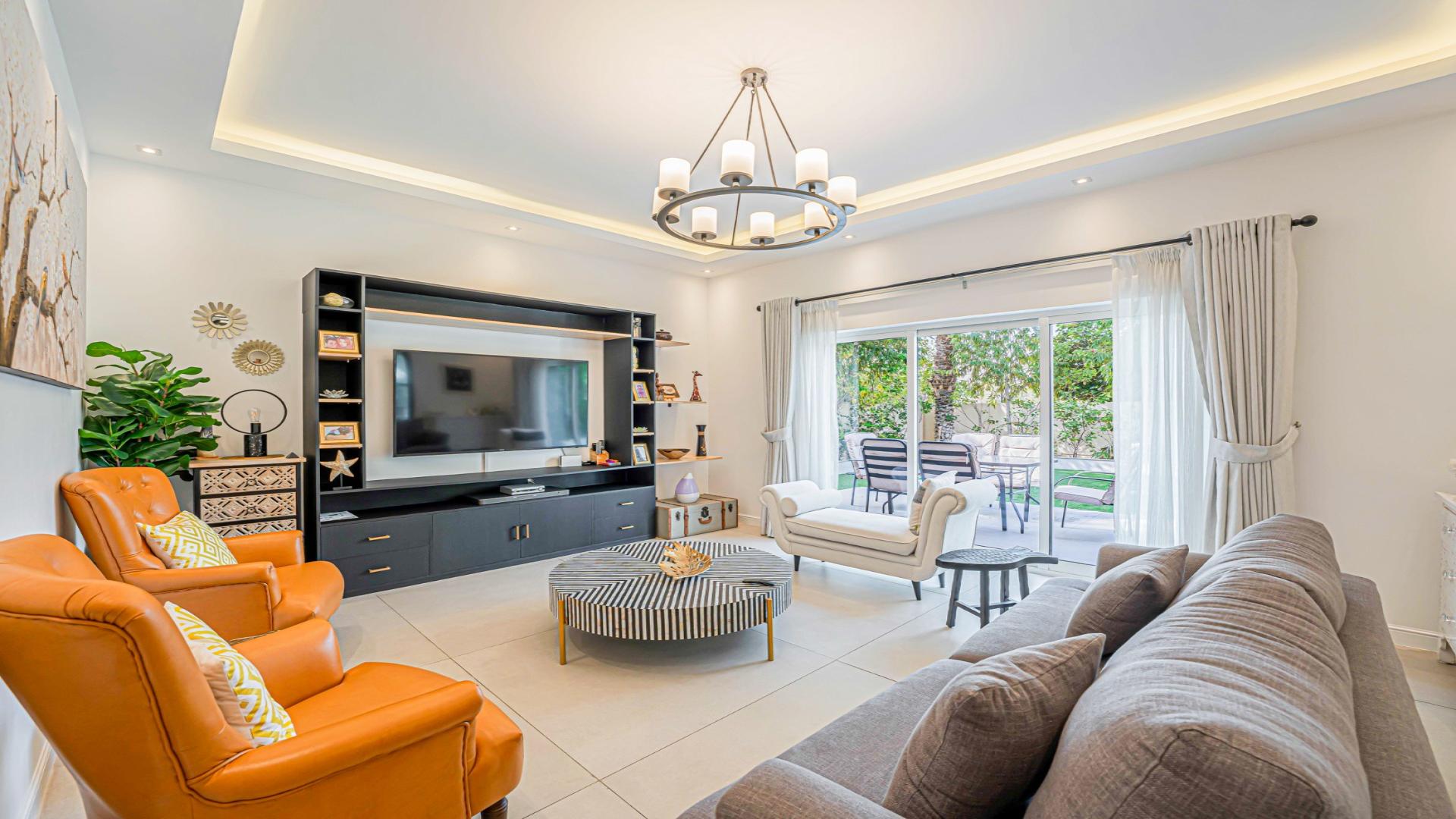 Luxurious living room in 4-bedroom Dubai Marina apartment, modern decor, spacious seating area
