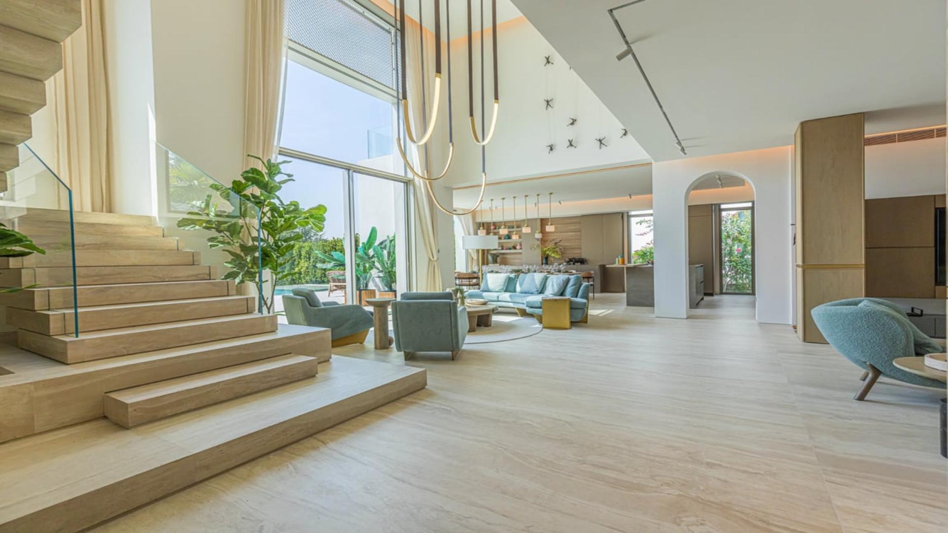 Luxurious villa living room in Jumeirah Islands with modern decor and park views