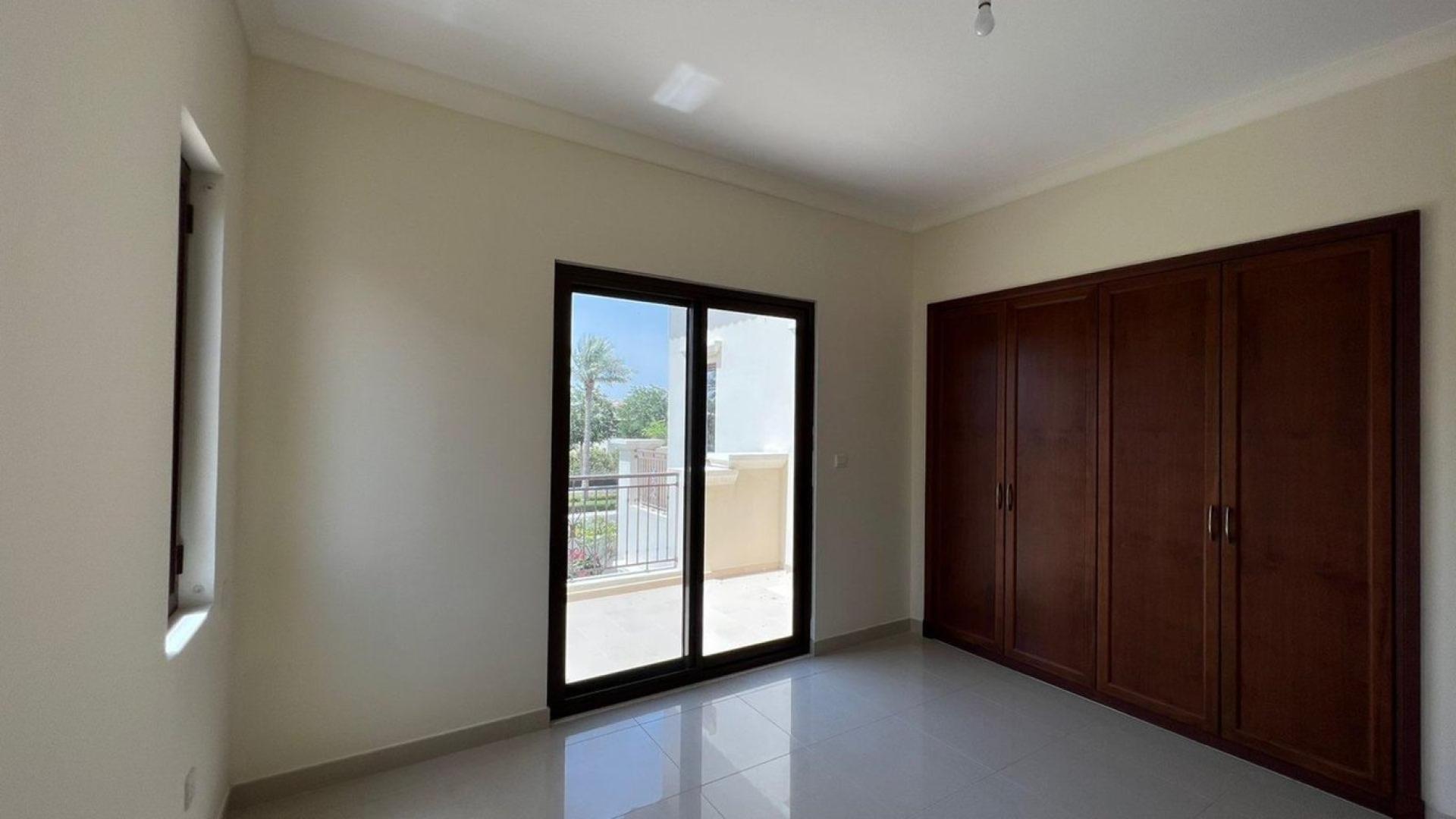 "Elegant bathroom in 4-bedroom villa, Rosa, Arabian Ranches 2, with double sink vanity.","Bright bedroom with balcony access in Rosa villa, Arabian Ranches 2, for sale.",Empty bedroom with large windows and balcony view in Rosa Villa, Arabian Ranches 2
