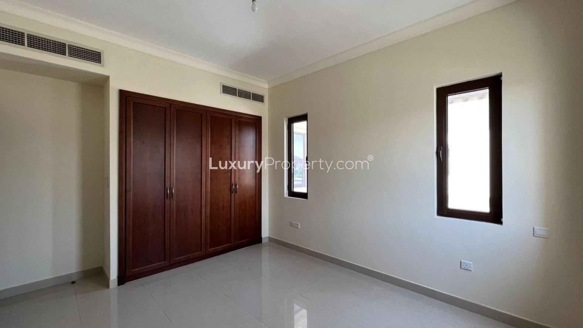 Empty bedroom with wooden built-in wardrobes in Rosa Villa, Arabian Ranches 2