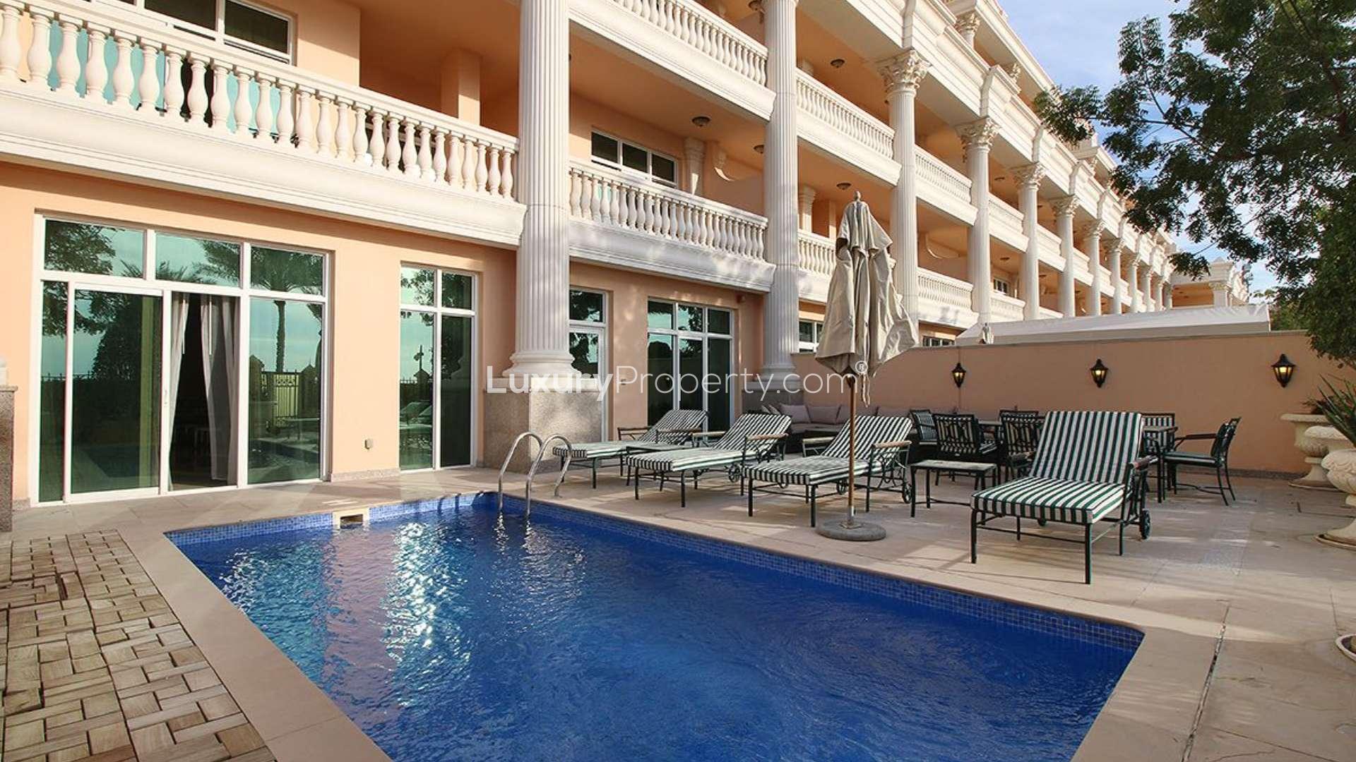 Luxurious furnished living room in Kempinski apartment, Palm Jumeirah, with elegant decor and chandeliers