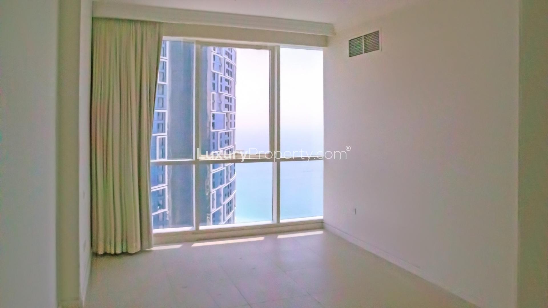 "Bright room with large window offering sea view in Al Bateen Residences apartment.","Spacious balcony with panoramic sea views at Al Bateen Residences, Jumeirah Beach Residence.",Modern kitchen with sea views in Jumeirah Beach Residence apartment for rent