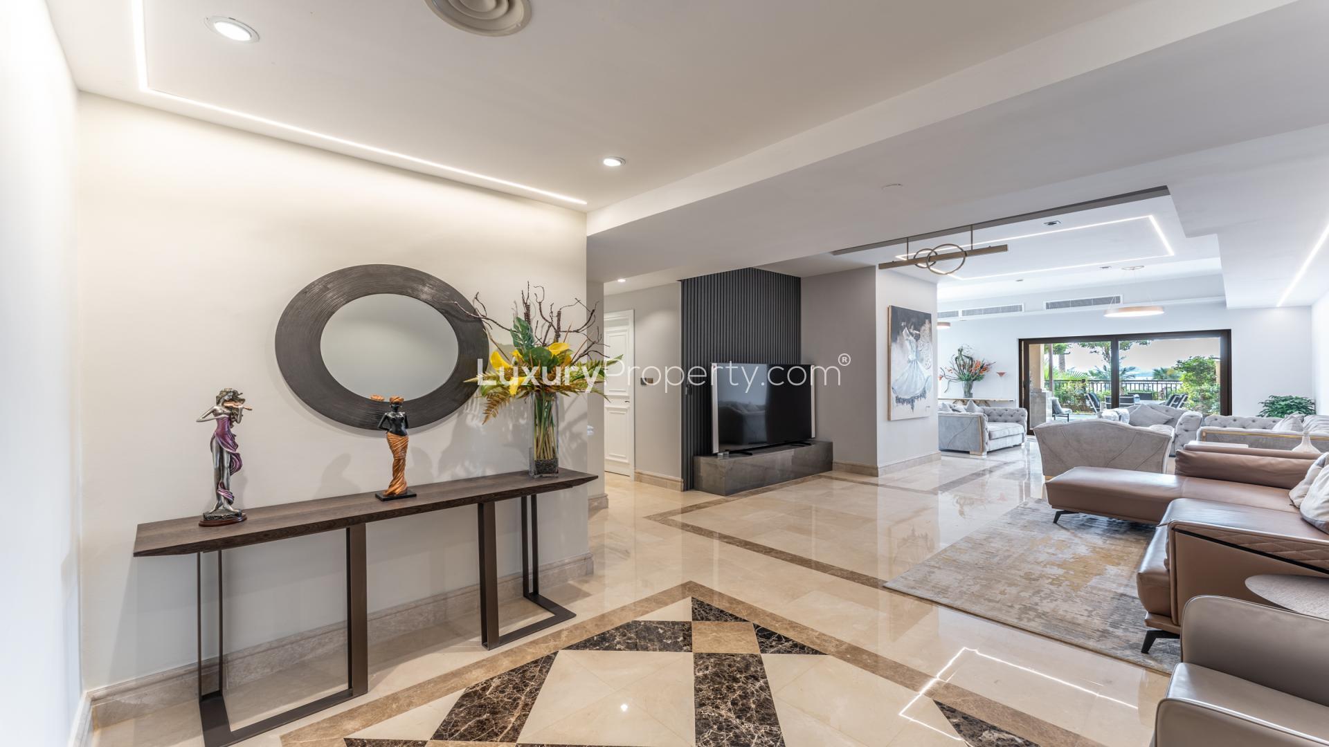 Luxurious dining and living area in Palm Jumeirah apartment with garden view