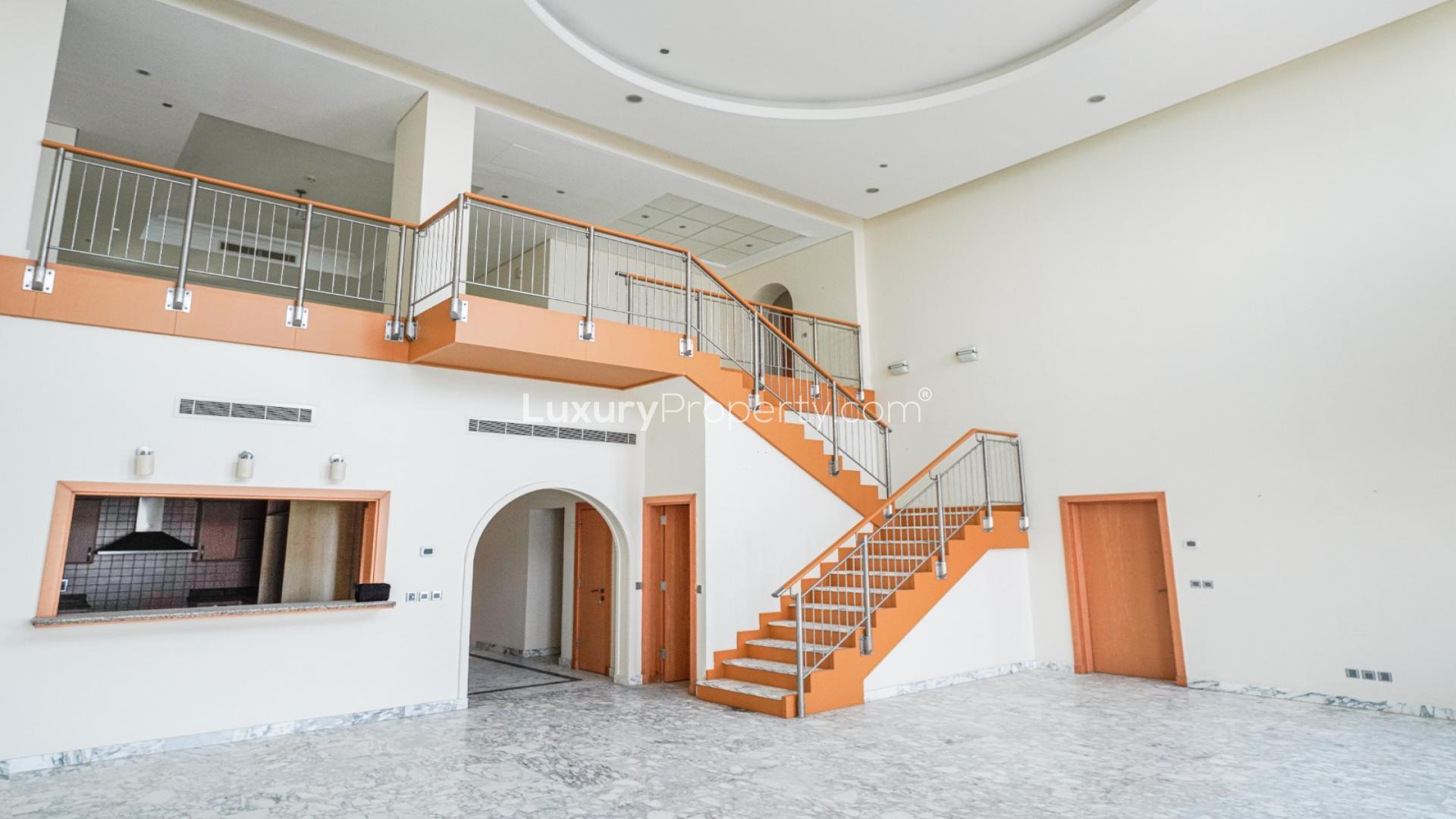 Duplex penthouse hallway with marble floors, arched doorway, and natural light in Palm Jumeirah