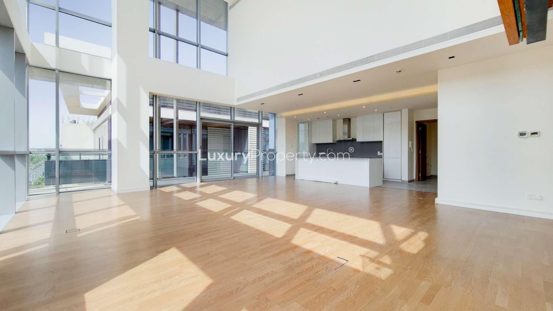 Spacious living area with wooden floors and large windows in City Walk duplex, Dubai