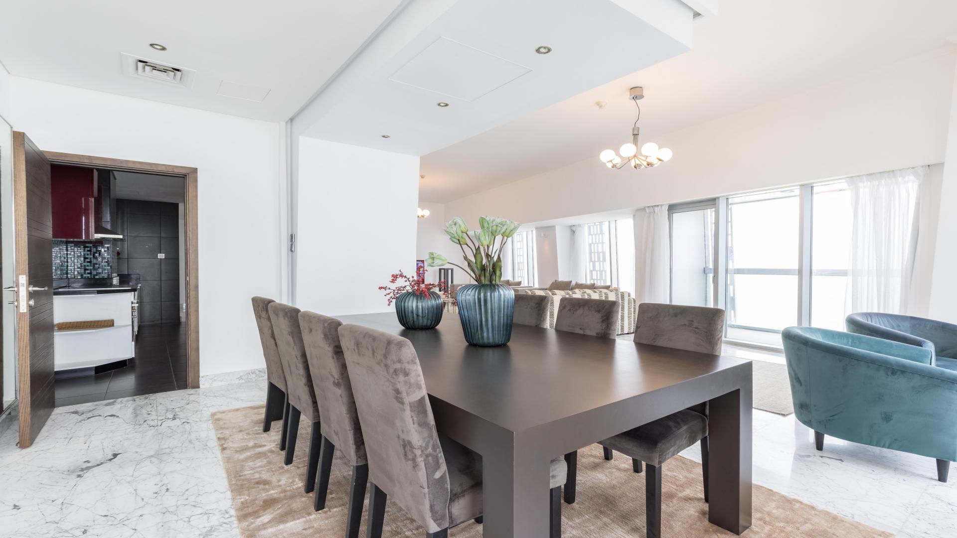 Luxury dining area in fully furnished Dubai Marina penthouse, Cayan Tower, with sea views