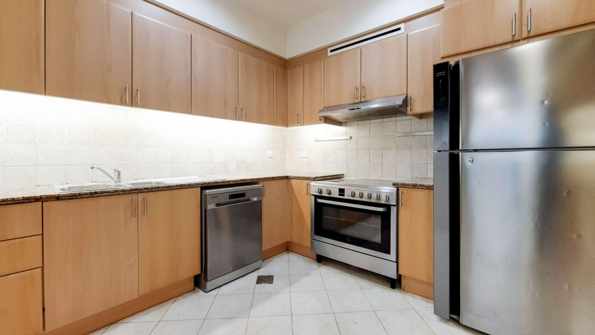 Spacious living area in Dubai Marina apartment, Emaar 6 Towers, with modern kitchen