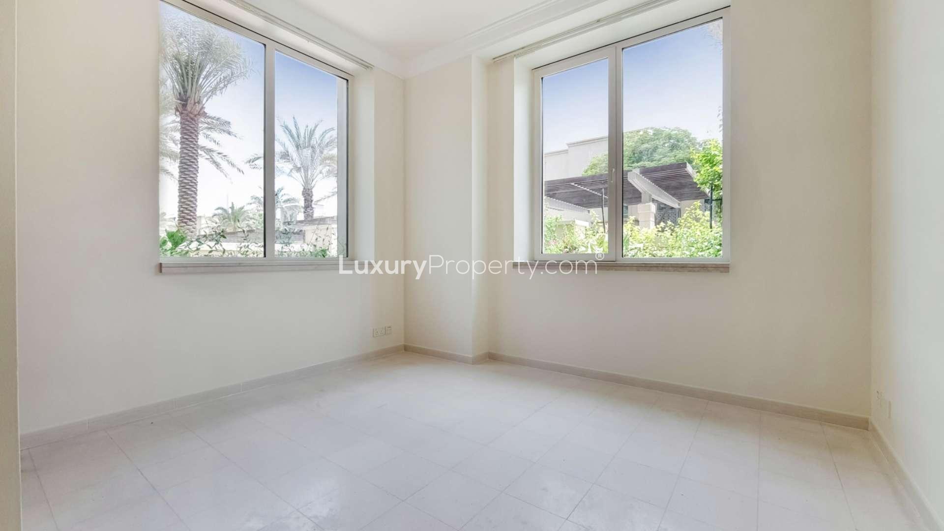 Modern kitchen in Dubai Marina apartment with stainless steel appliances and wooden cabinetry