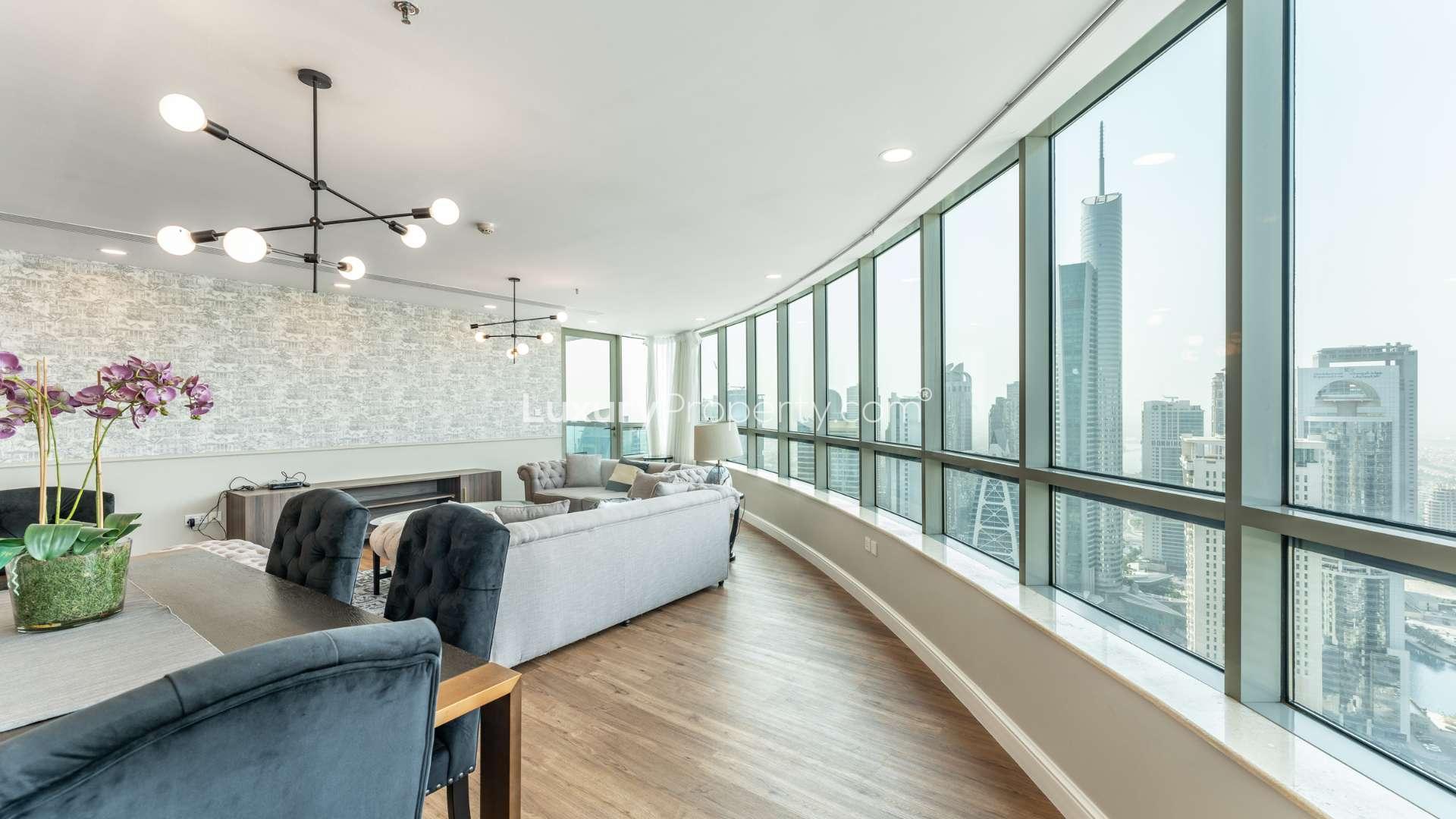 Luxurious living room in Horizon Tower apartment, Dubai Marina, with modern decor and city views