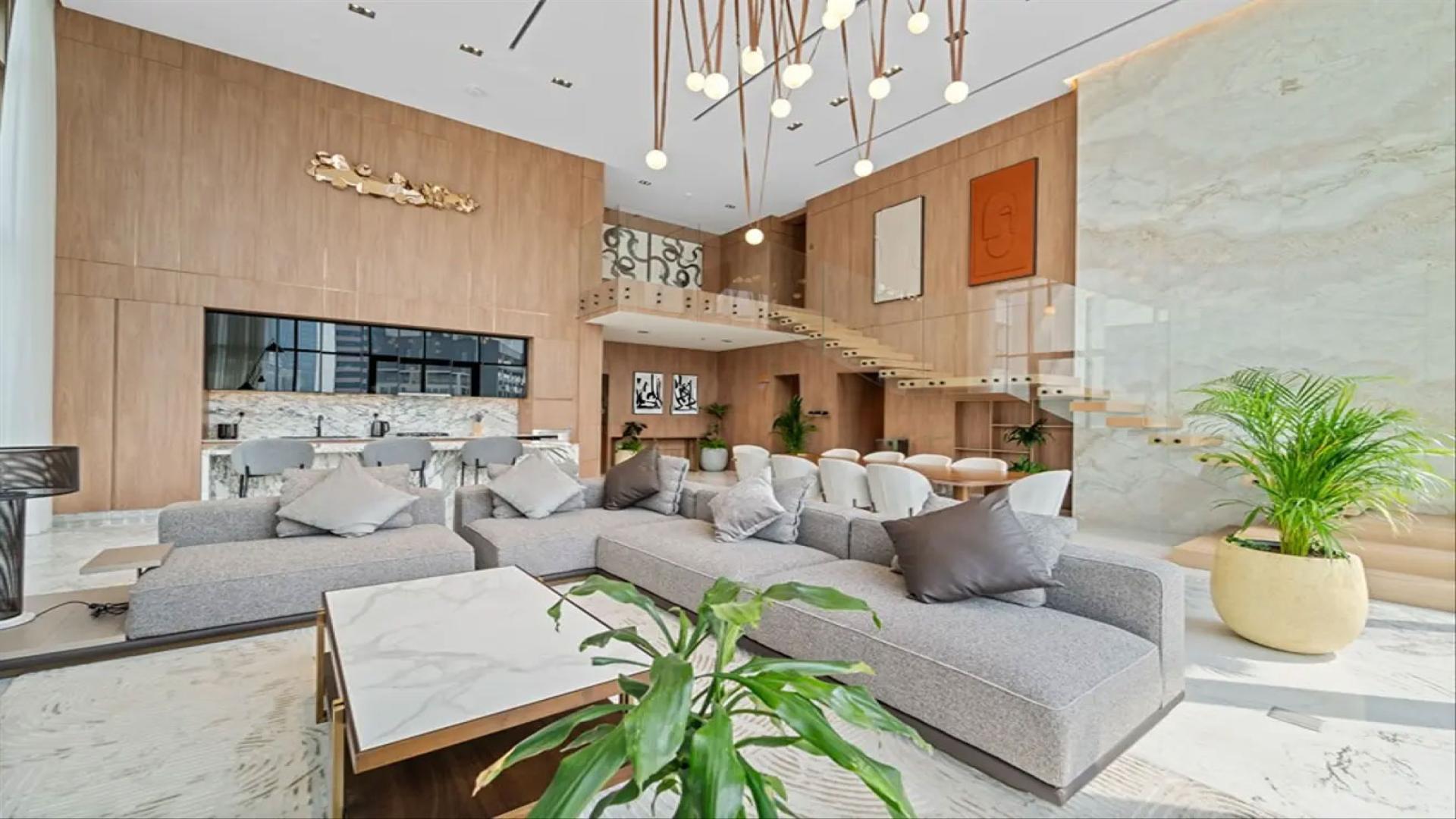 Luxurious living room in 4-bedroom duplex, Business Bay, with modern decor and large windows