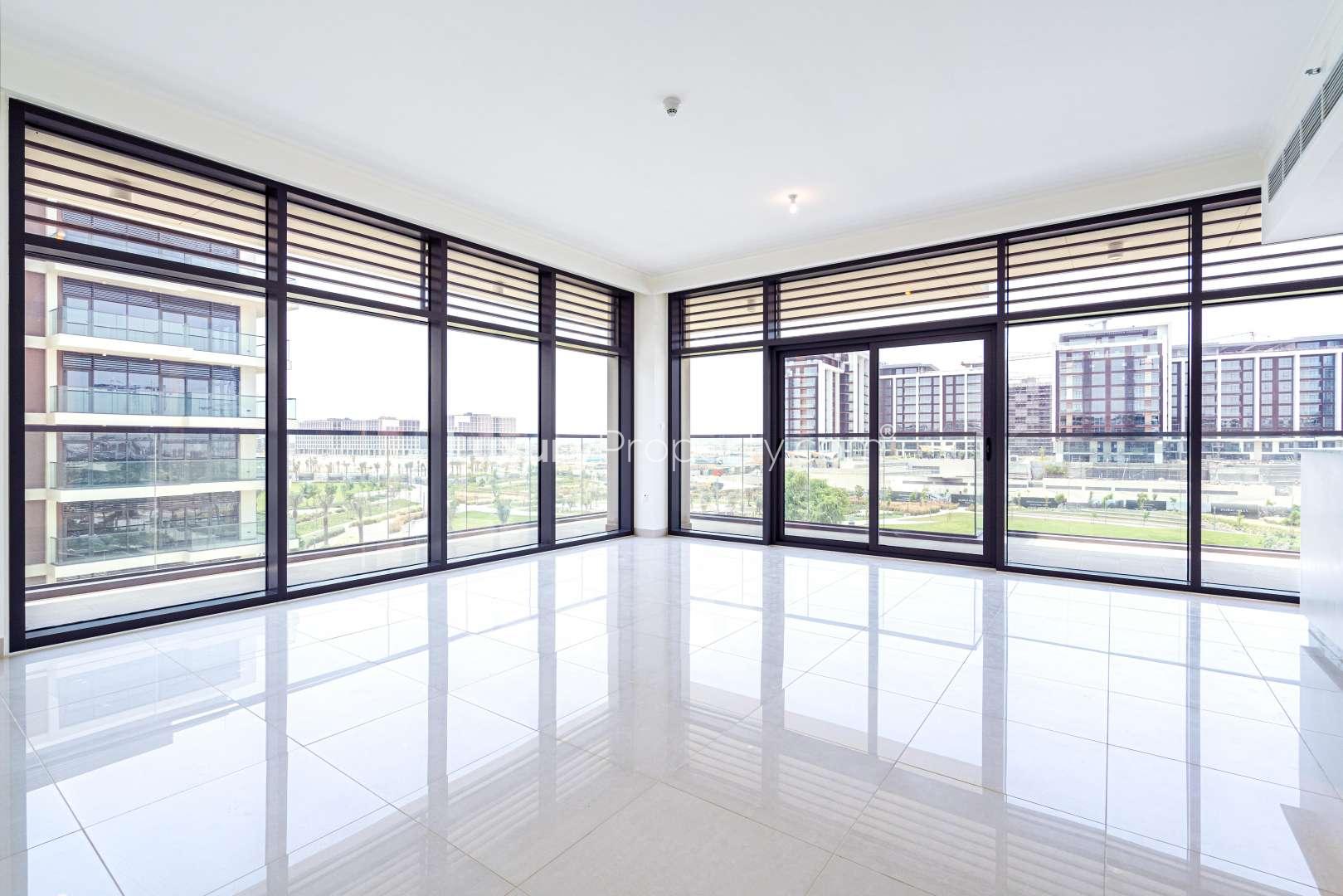 "Spacious living area with large windows in Mulberry duplex, Dubai Hills Estate apartment.",Outdoor pool area of a luxury duplex apartment in Mulberry, Dubai Hills Estate