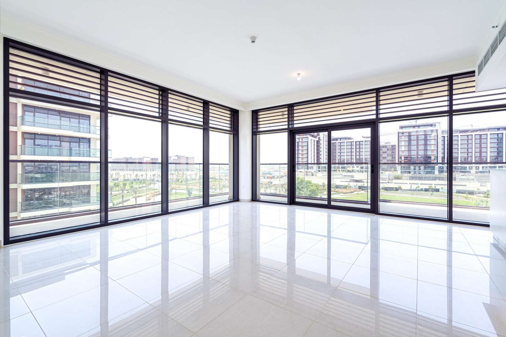 "Spacious living area with large windows in Mulberry duplex, Dubai Hills Estate apartment.",Outdoor pool area of a luxury duplex apartment in Mulberry, Dubai Hills Estate