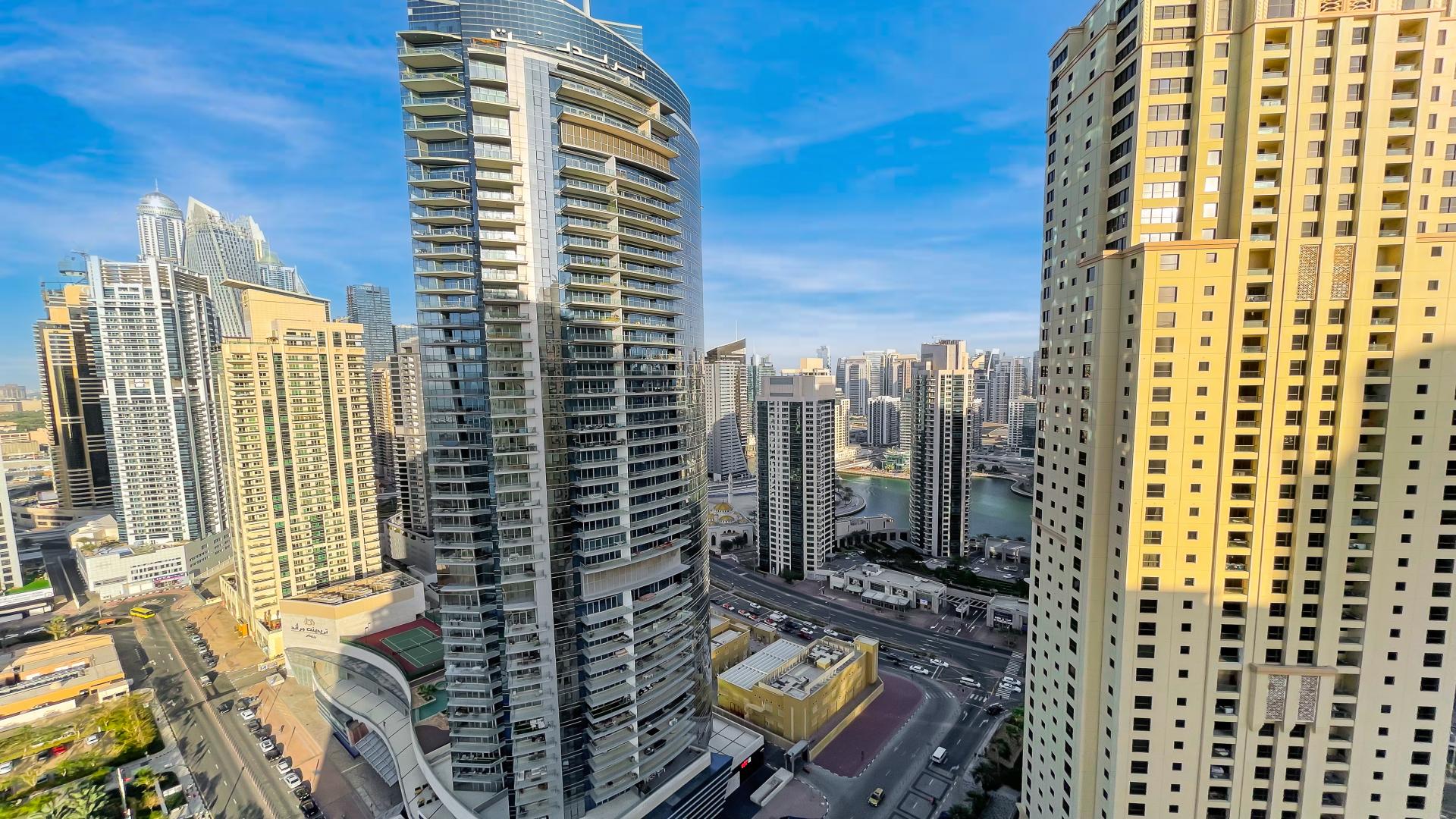 Modern kitchen in Jumeirah Beach Residence apartment, featuring sleek appliances and ample cabinetry