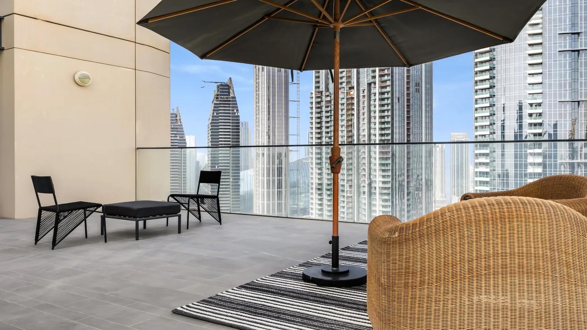 Luxurious living room in Downtown Dubai apartment with Burj Khalifa view, modern furnishings