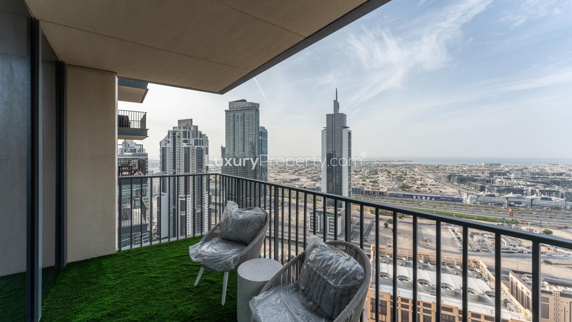 Furnished living room in Downtown Dubai apartment with large windows and city views