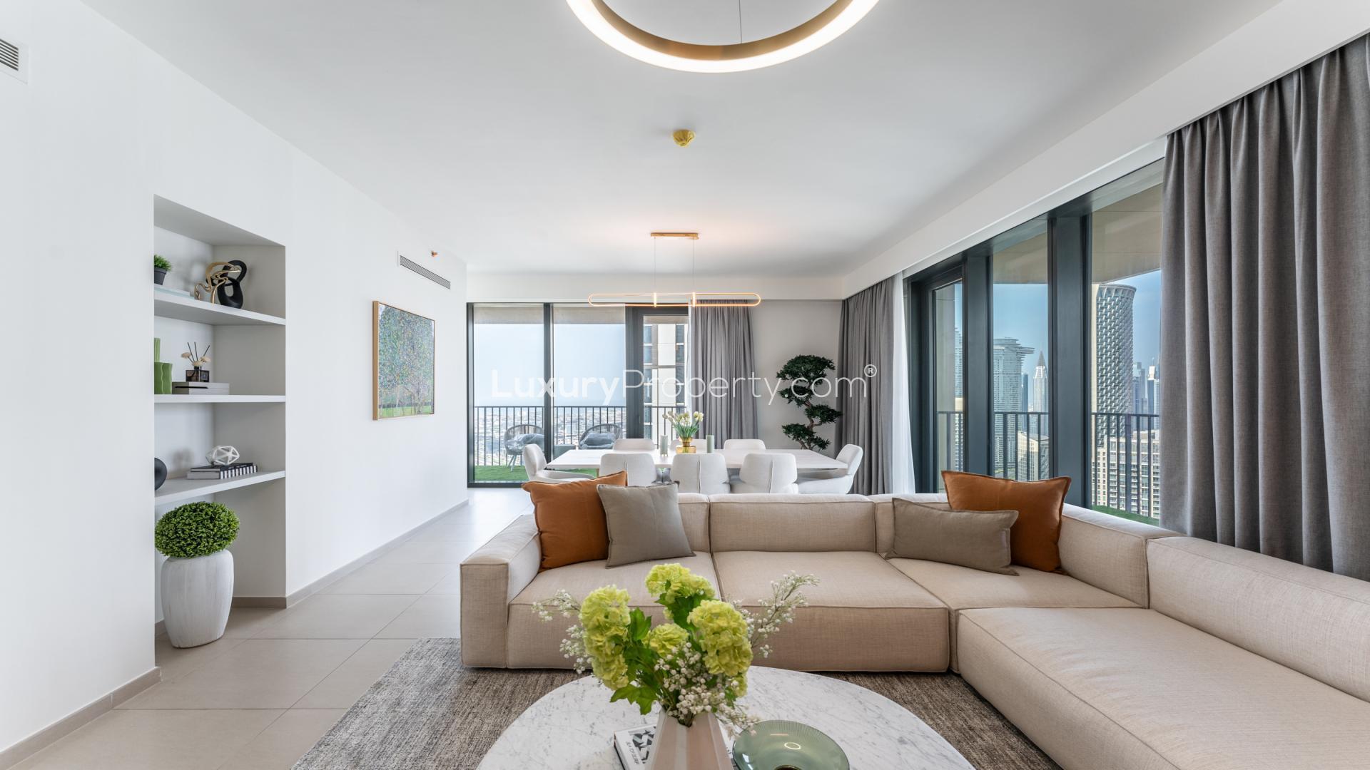 Furnished living room with modern decor in Downtown Dubai apartment, featuring large windows and views