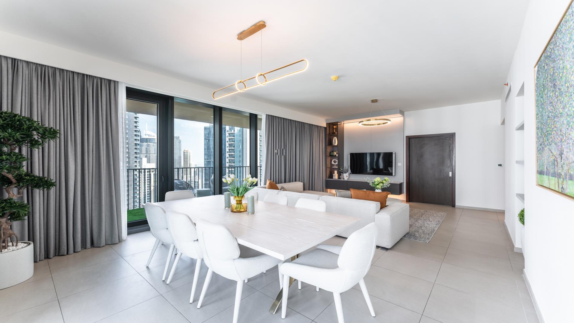 Furnished apartment balcony with chairs, Downtown Dubai skyline and fountain views, BLVD Heights