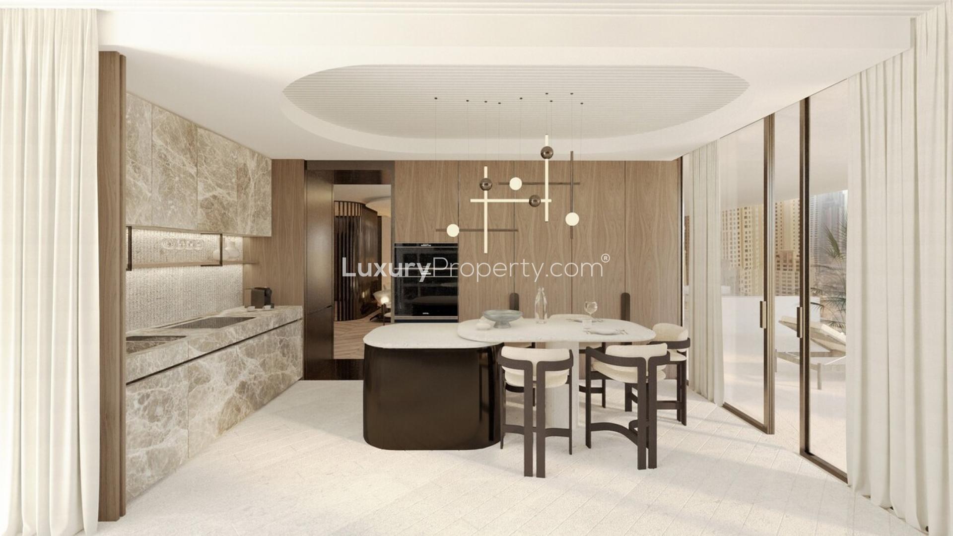 "Elegant entrance of Ritz-Carlton Residences in Business Bay, showcasing luxury architecture and design.",Modern kitchen and dining area in Ritz-Carlton Apartment, Business Bay, for sale