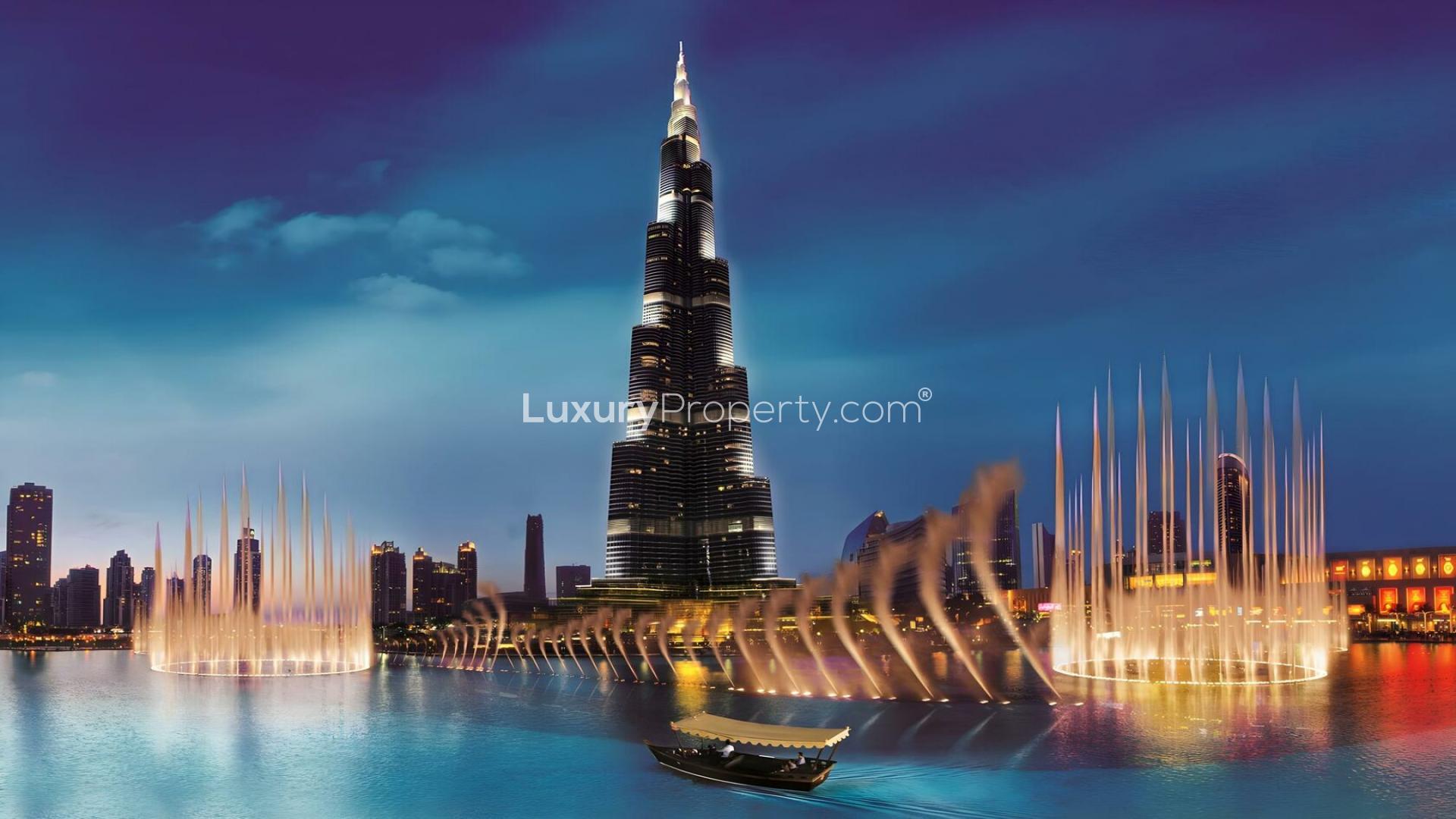 Night view of Downtown Dubai skyscrapers near Mercedes-Benz Places apartment for sale
