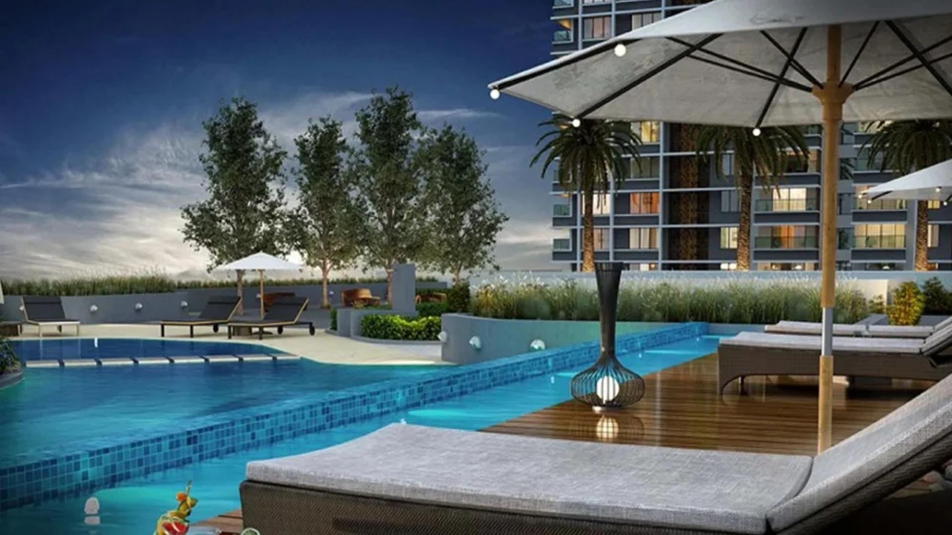 Luxurious Marina One apartments in Kochi with poolside view and elegant lounge area.