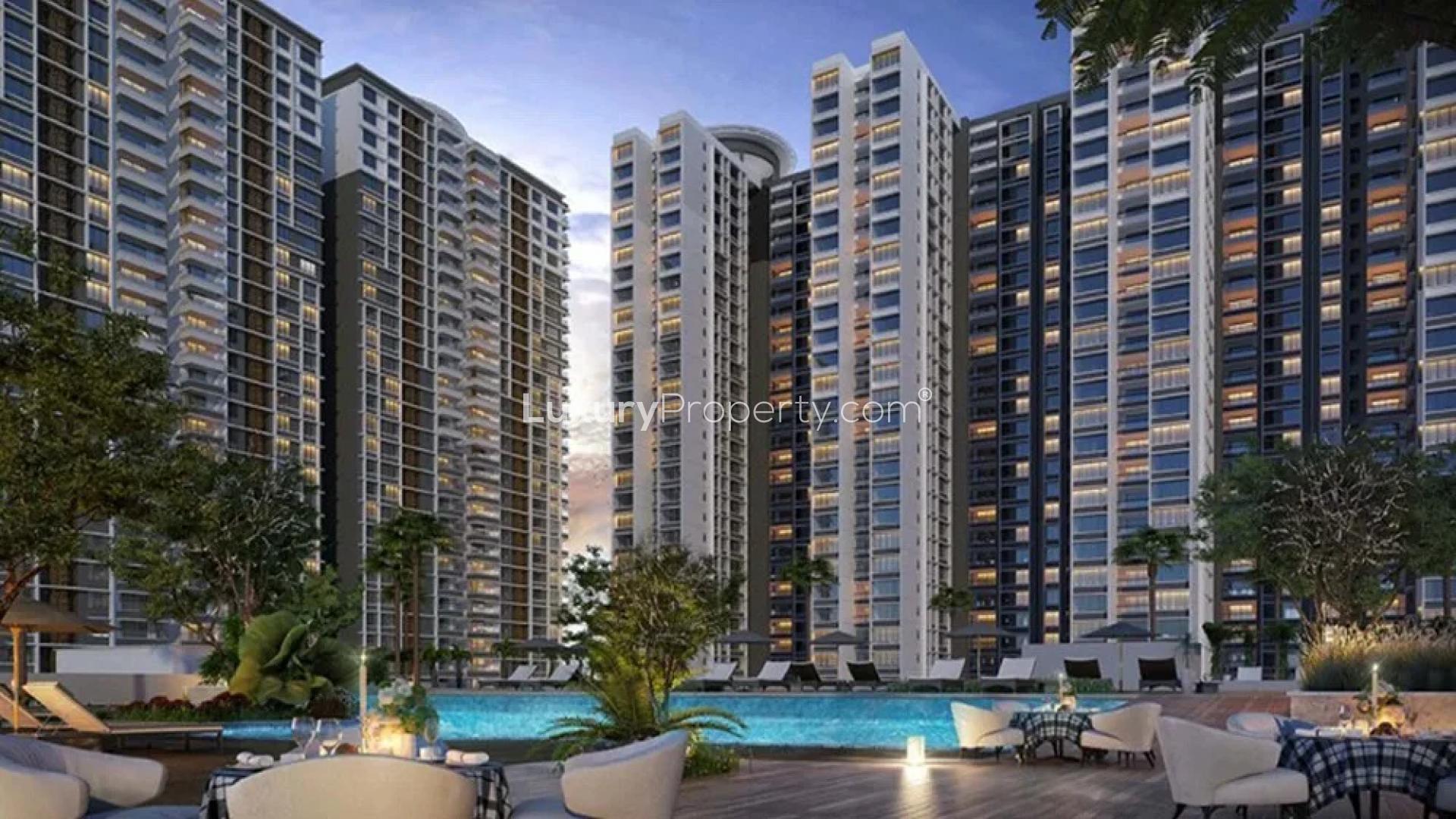 Elegant Marina One apartments in Kochi with poolside view, palm trees, and modern architecture