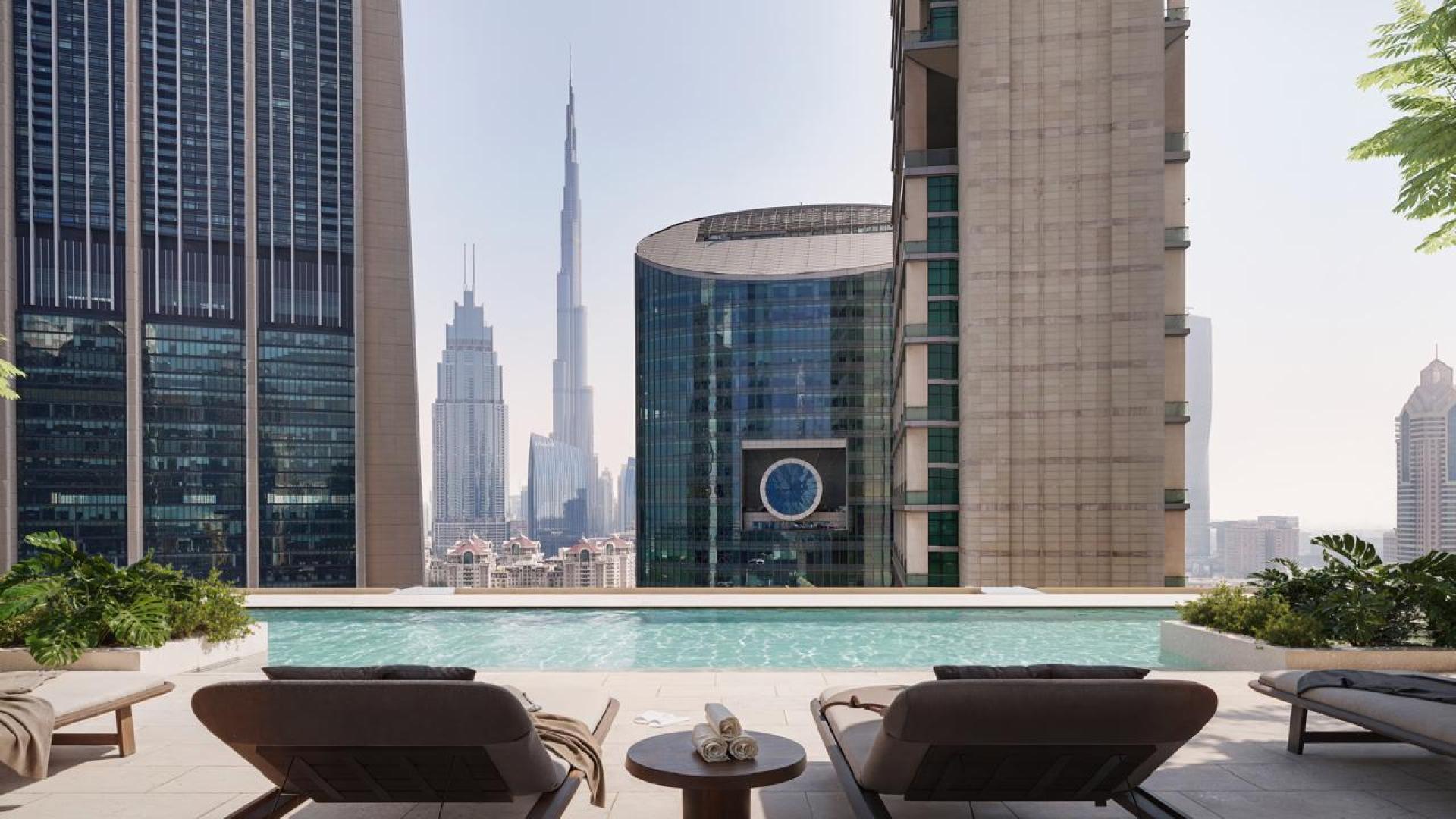 Modern kitchen and living area in DIFC Heights apartment with city skyline view