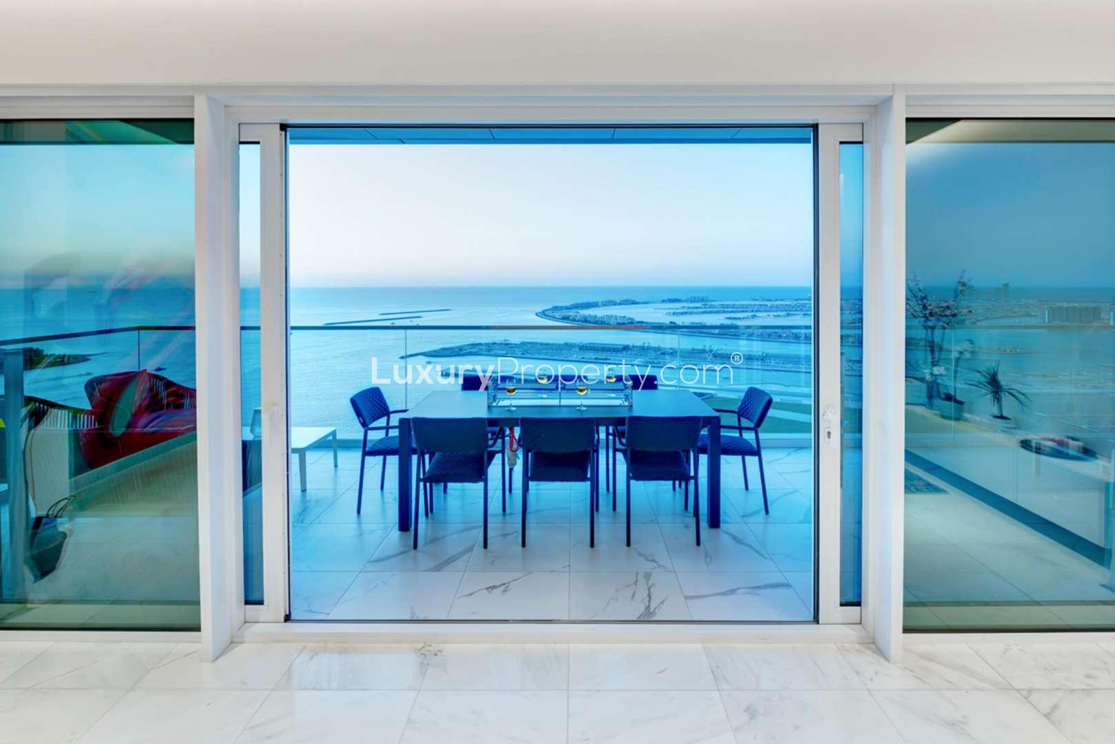 Stylish 4-bedroom apartment living room with vibrant mural and sea view in Jumeirah Beach Residence