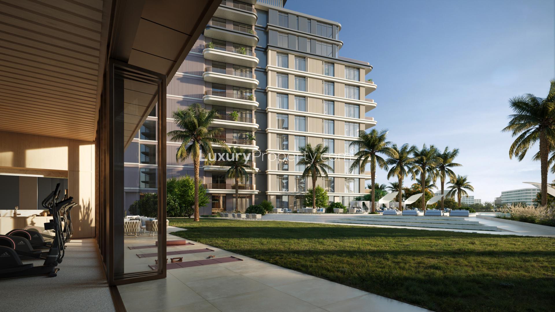 Luxury entrance of 4-bedroom duplex apartment, Dubai Islands, with modern architecture and lush greenery