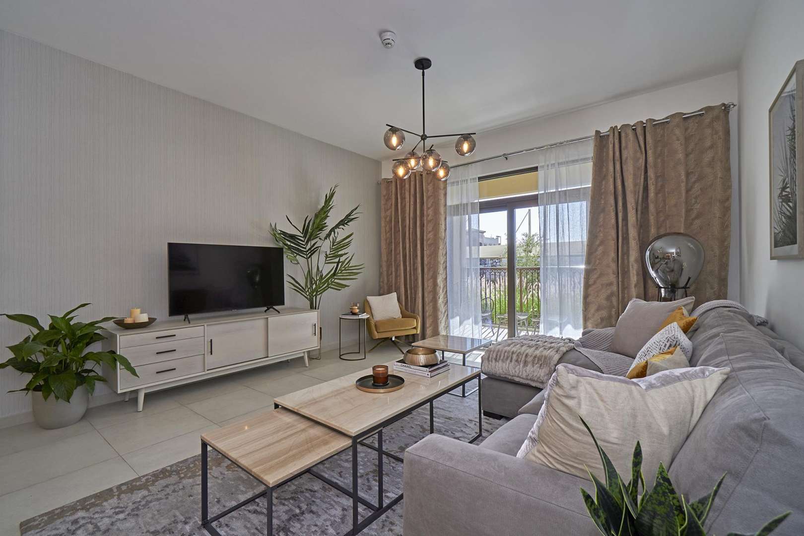 Spacious living room in luxurious Asayel apartment, featuring modern decor and elegant lighting