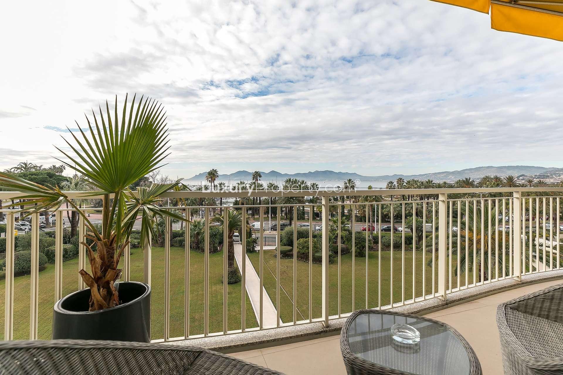 Luxurious bedroom in renovated Cannes apartment, French Riviera, with modern decor and natural light