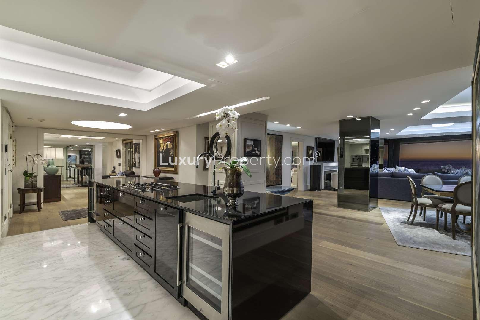 Luxurious living room in Clifton apartment with ocean view, modern decor, and cozy seating