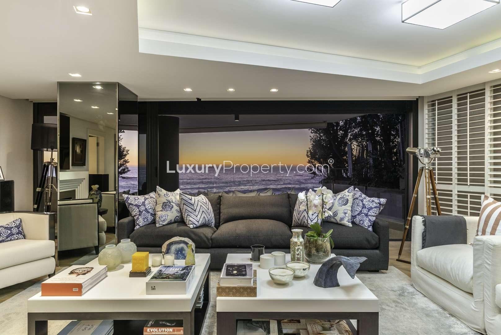 Luxurious living room in 5-bedroom Clifton apartment with ocean view at sunset