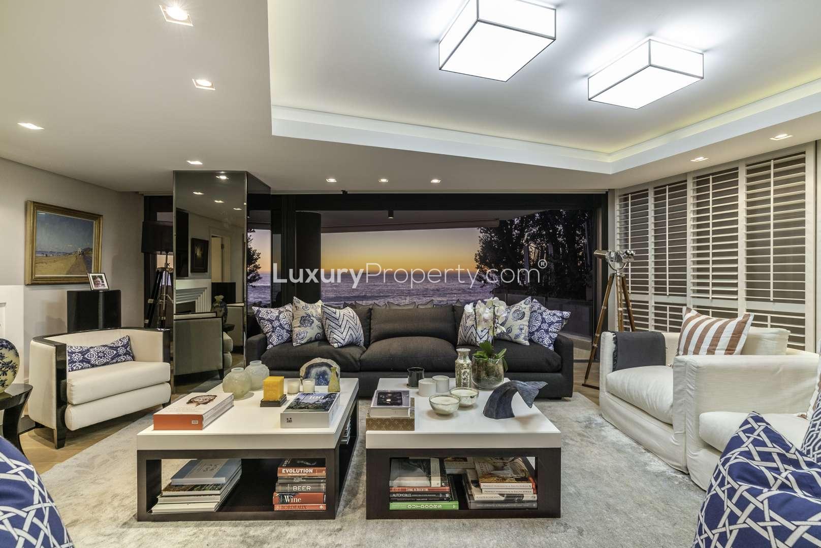 Luxurious Clifton apartment living room with ocean view at sunset, Cape Town