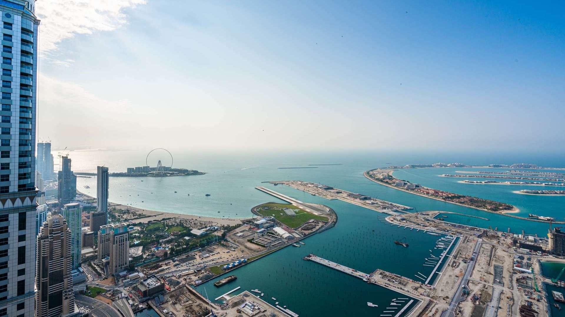 Modern kitchen and dining area in Elite Residence penthouse, Dubai Marina with panoramic views