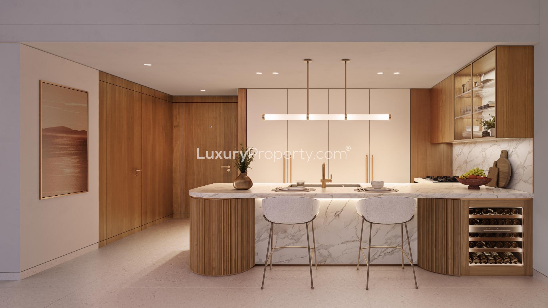 Modern kitchen in Ellington Beach House apartment, Palm Jumeirah. Marble island, sleek cabinetry
