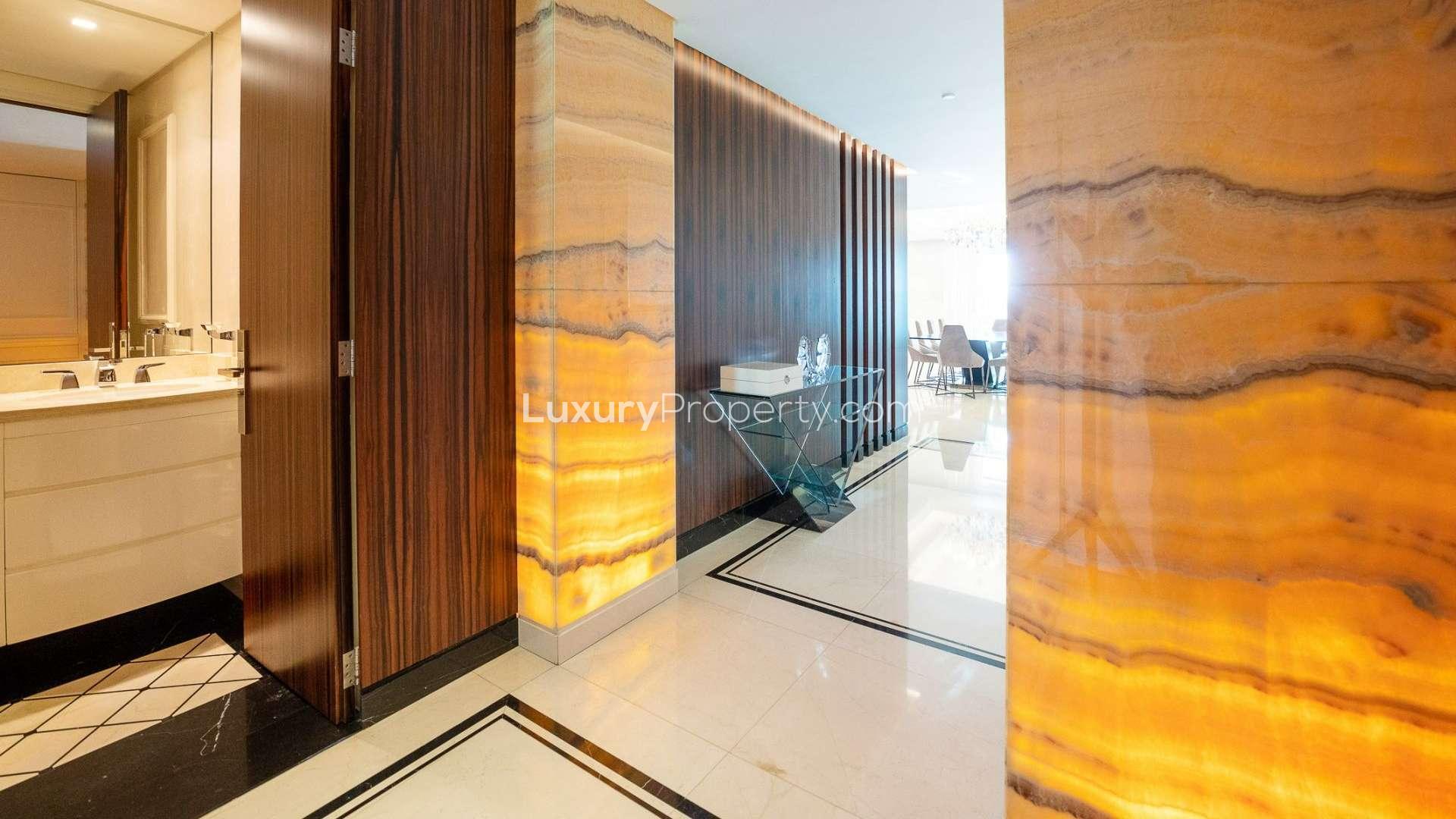Elegant hallway in 4-bedroom apartment, Fairmont The Palm, with luxurious wood and marble features