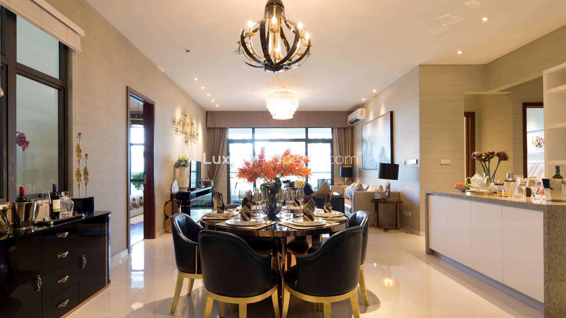 "Modern kitchen in four-bedroom Forest City apartment, Malaysia, with elegant dining area.",Luxurious dining and living area in four-bedroom apartment, Forest City, Malaysia