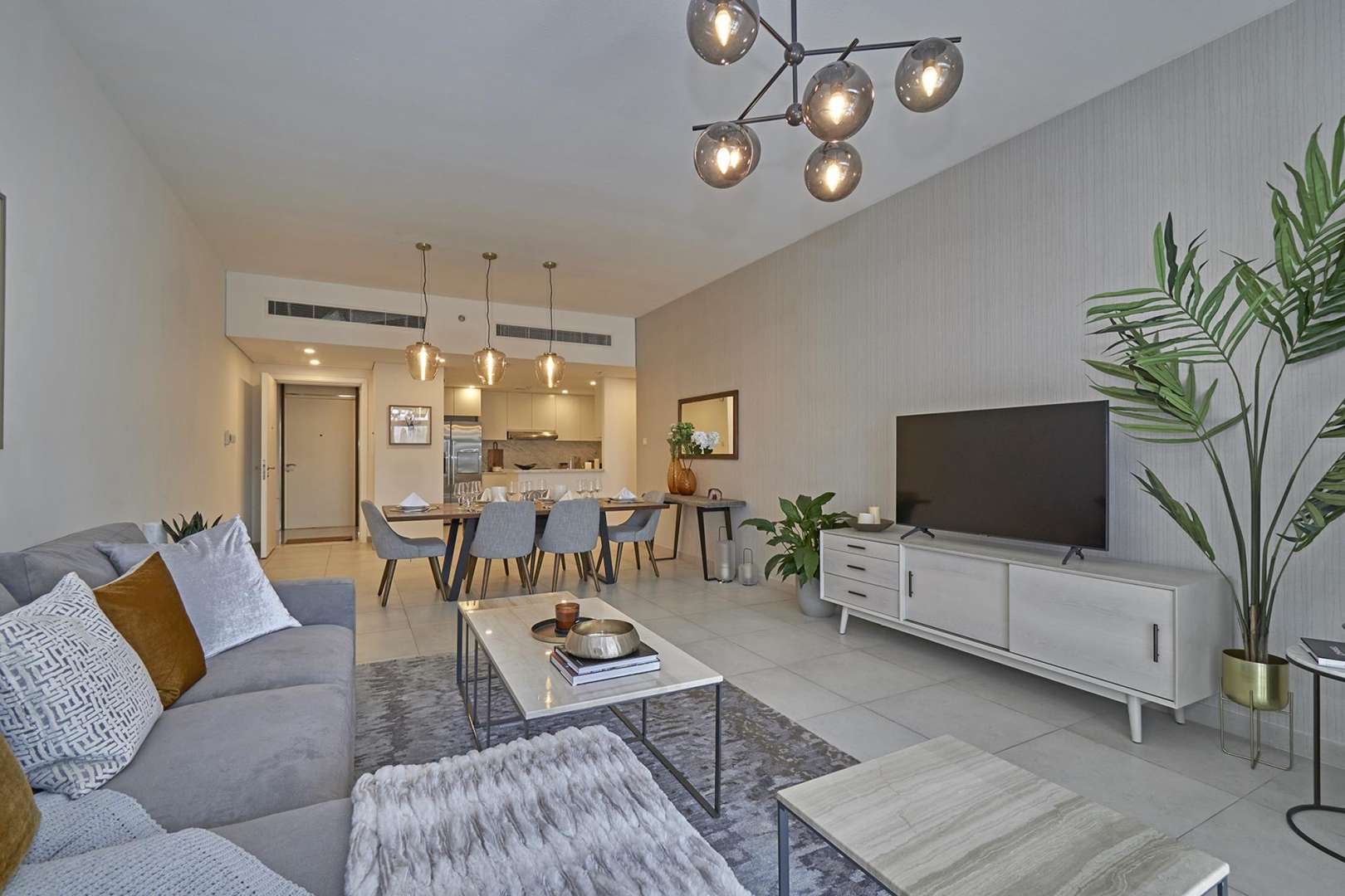 Modern open-plan living and dining area in Jumeirah Living apartment, Umm Suqeim