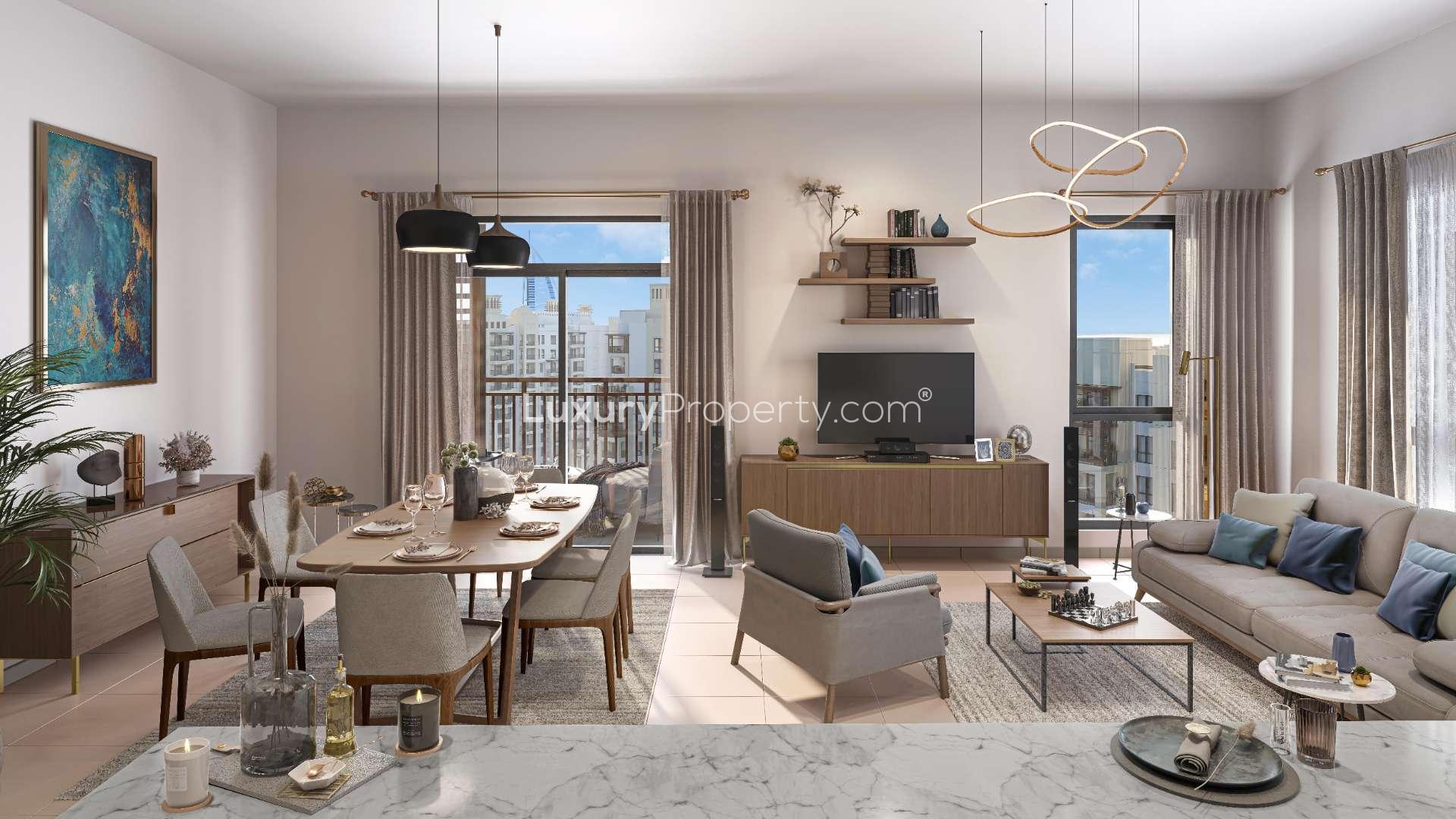 "Luxurious Madinat Jumeirah Living apartment exterior with lush gardens and palm trees, Umm Suqeim.","Modern living room in four-bedroom apartment, Madinat Jumeirah Living, Umm Suqeim, panoramic views.",Luxurious living room with panoramic views in Madinat Jumeirah Living apartment, Umm Suqeim