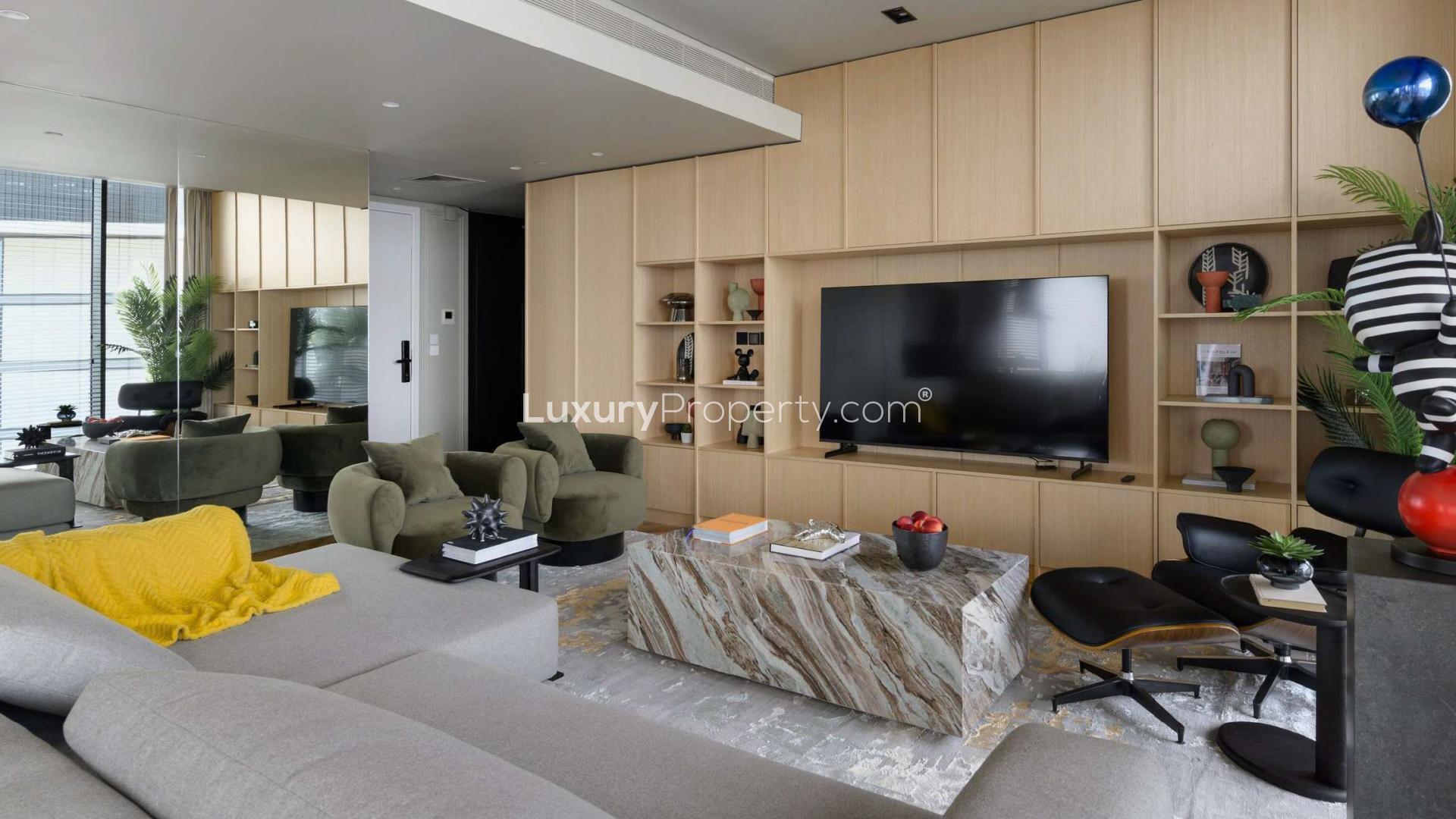 Partial sea view from Bluewaters apartment balcony, surrounded by modern buildings and palm trees