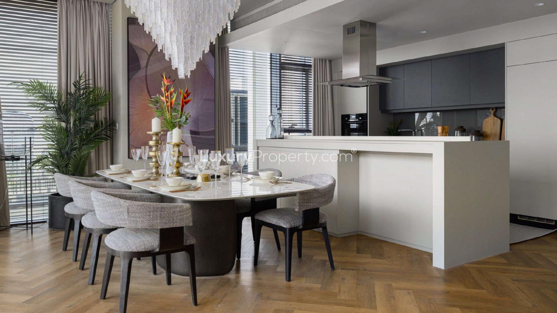 Modern living room in Bluewaters 4-bedroom apartment, featuring stylish decor and large TV