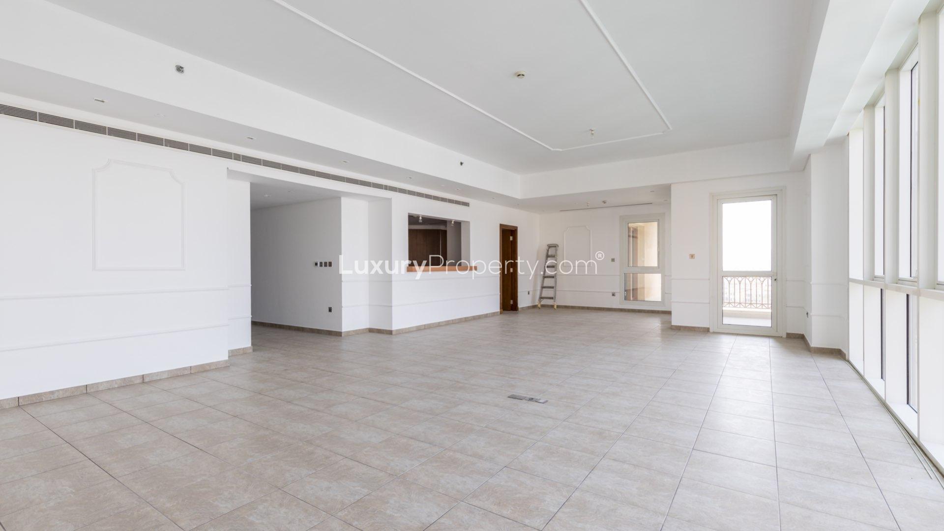 Spacious living area with large windows and marina views in Palm Jumeirah apartment