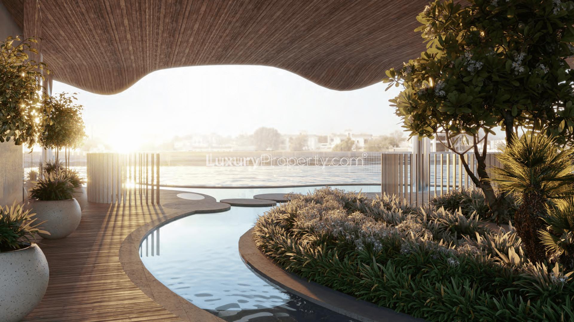 Luxurious poolside view at Mr. C Residences, Jumeirah 2, showcasing serene waterfront landscape
