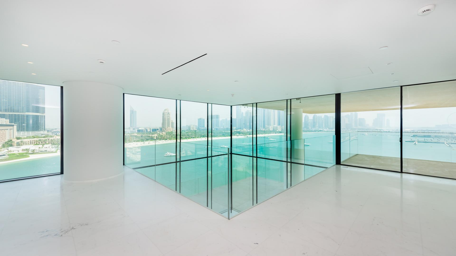 "Spacious terrace with sea views at luxury Palm Jumeirah apartment for sale.",Luxury apartment interior with panoramic sea views at One Palm Jumeirah, Dubai